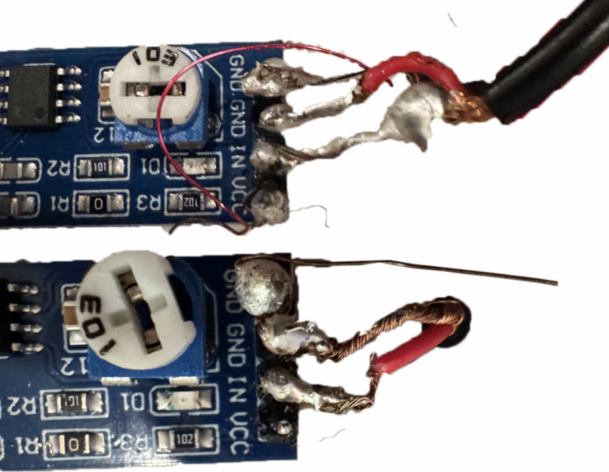Close-up of early soldering failures on small amplifier wiring, with rough joints, exposed copper, and magnet wire connections around a blue board